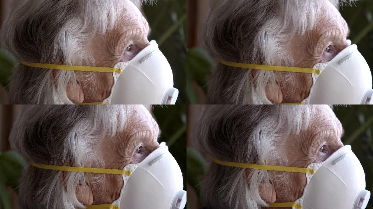 悲痛欲绝的老年高加索妇女的特写镜头看着窗外感到孤独戴着n95防护口罩防止COVID传染性非典型肺炎传