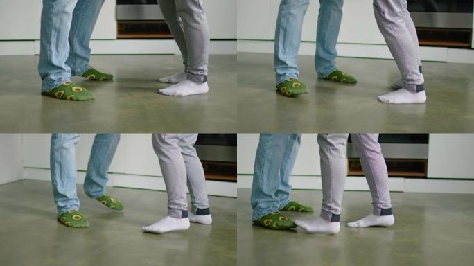 特写脚年轻男女在厨房跳舞