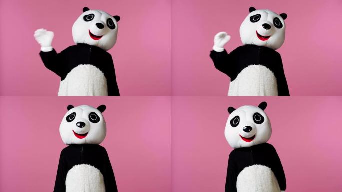 穿着熊猫熊服装的人挥舞着粉红色的手