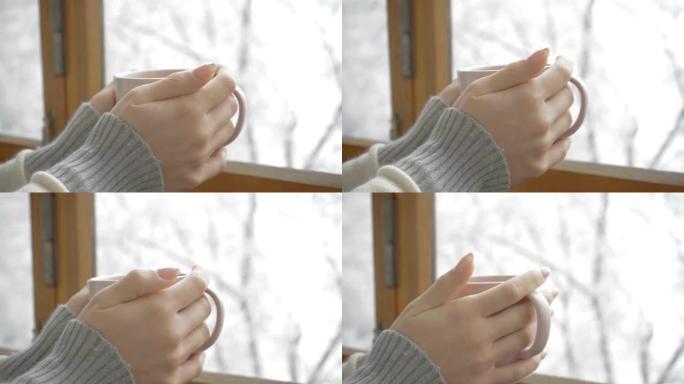 一个女孩手中的一杯芳香咖啡，冬日