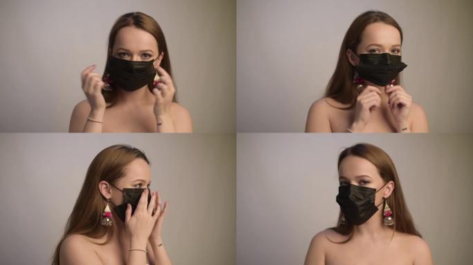 女孩展示了如何正确戴口罩。女孩戴上黑色面具，展示如何戴它。戴着面具的白色背景的女孩。