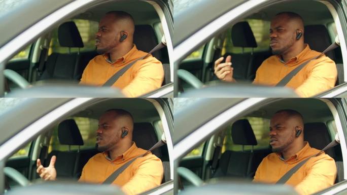 男性司机在汽车上使用无线电话耳机