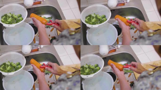 女人在家用菜刀在砧板上剥胡萝卜和切碎胡萝卜。