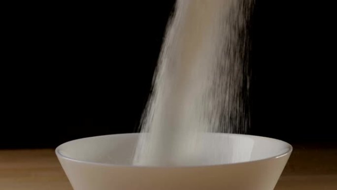 Sugar pouring into a ball