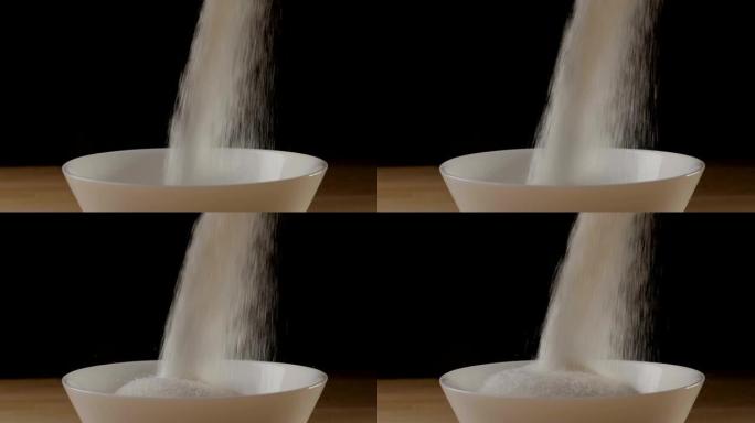 Sugar pouring into a ball