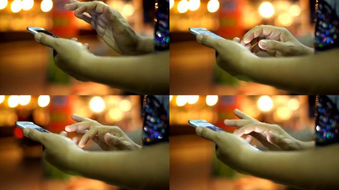女人的特写镜头在晚上使用智能手机