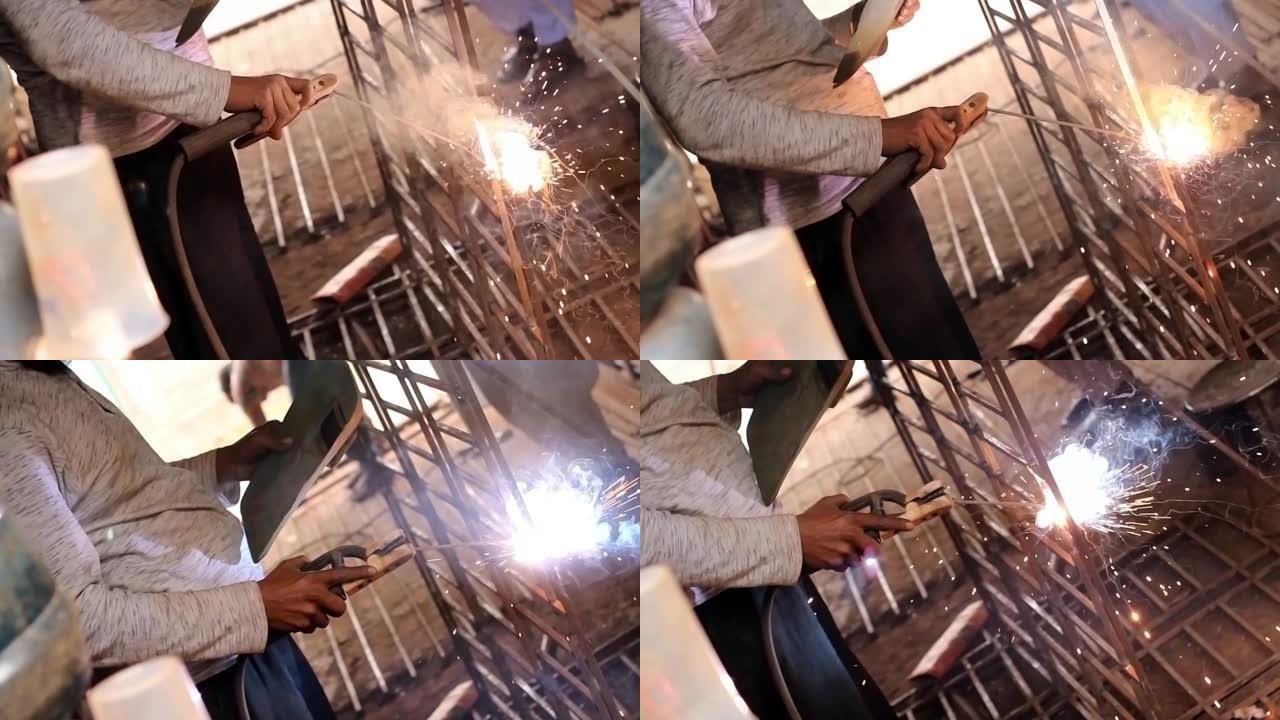 孟加拉国达卡-2020年5月22日: 焊工架设技术钢。工业用钢焊机在工厂技术。