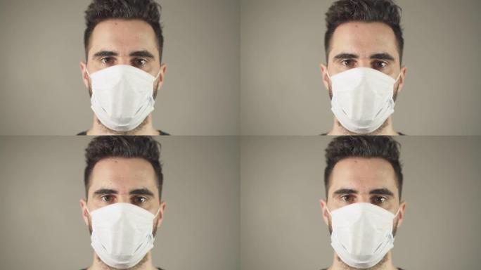 在法国新型冠状病毒肺炎大流行病毒期间，戴着外科口罩、棕色头发和眼睛的孤立男子的特写镜头，面对演播室的