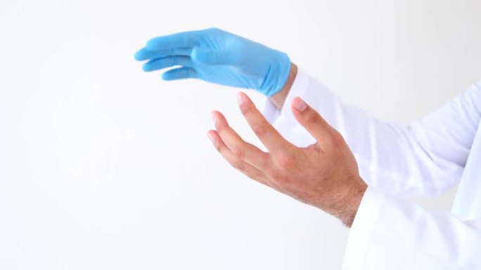 医生脱下或取下无菌手术手套，以阻止新型冠状病毒肺炎、2019-nCoV或冠状病毒的传播。