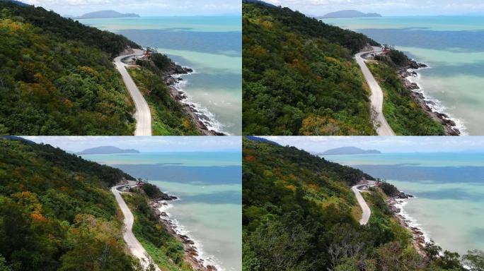 泰国南部蓝海旁的道路鸟瞰图。夏天的秋天山。平稳的无人机射击。