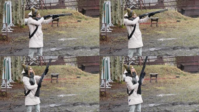 女孩用猎枪向射击场的目标射击。墨盒外壳12口径
