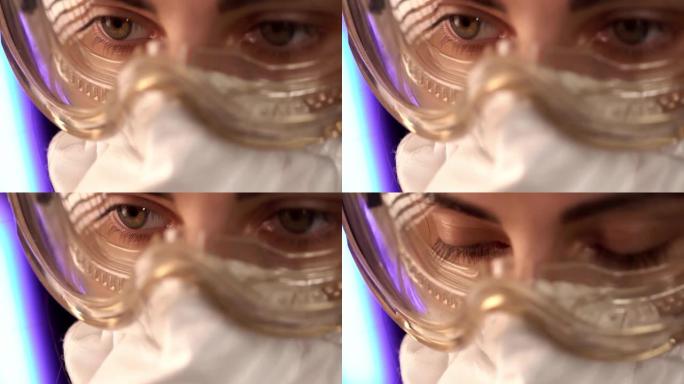 医生，病毒学家，戴着眼镜和医用口罩的科学家女性。戴着防护面具的医生眼睛。宏观特写。概念冠状病毒新型冠