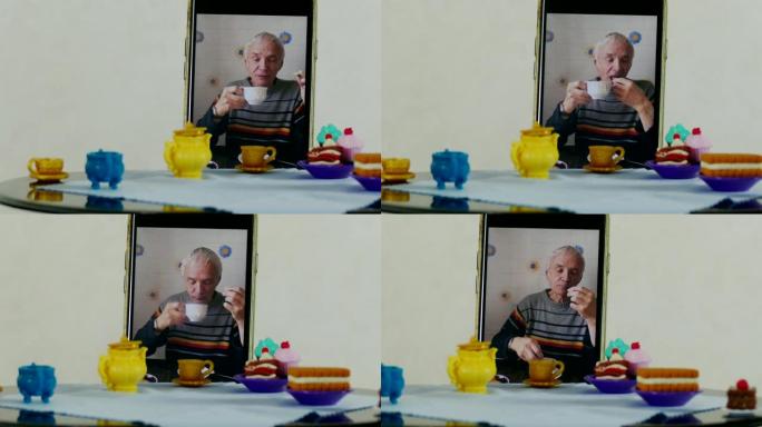 老人通过智能手机使用远程访问在娃娃桌上喝茶