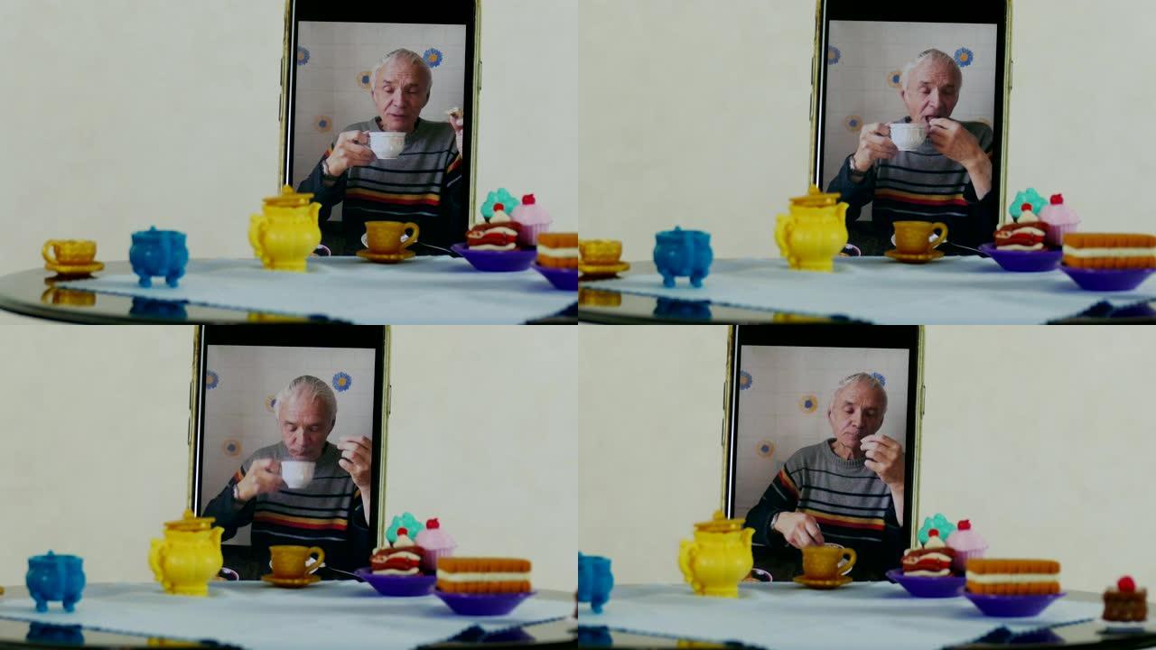 老人通过智能手机使用远程访问在娃娃桌上喝茶