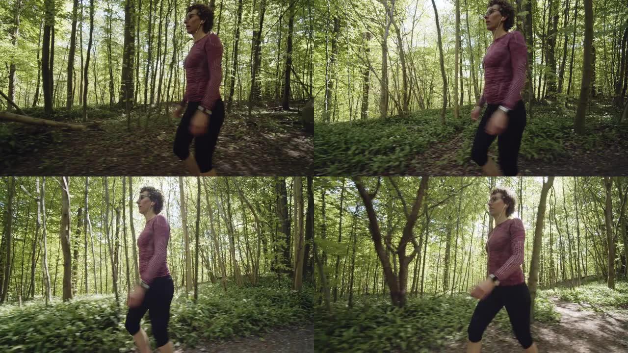 穿着黑色打底裤的女性快速行走，背景是森林树木的景色