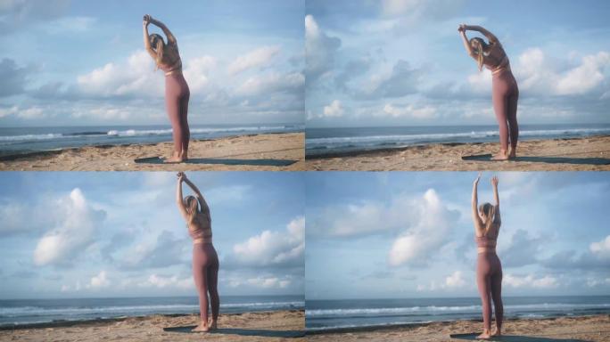 站在海洋海滩上的苗条女人做半月形瑜伽姿势