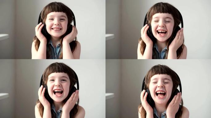 戴大型无线耳机的女孩听着笑。特写。