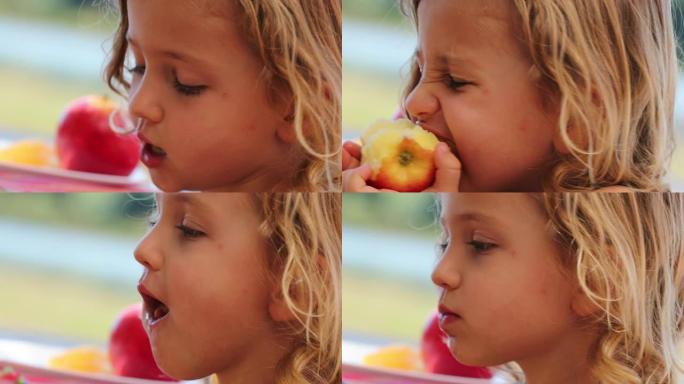 小女孩在外面吃苹果水果
