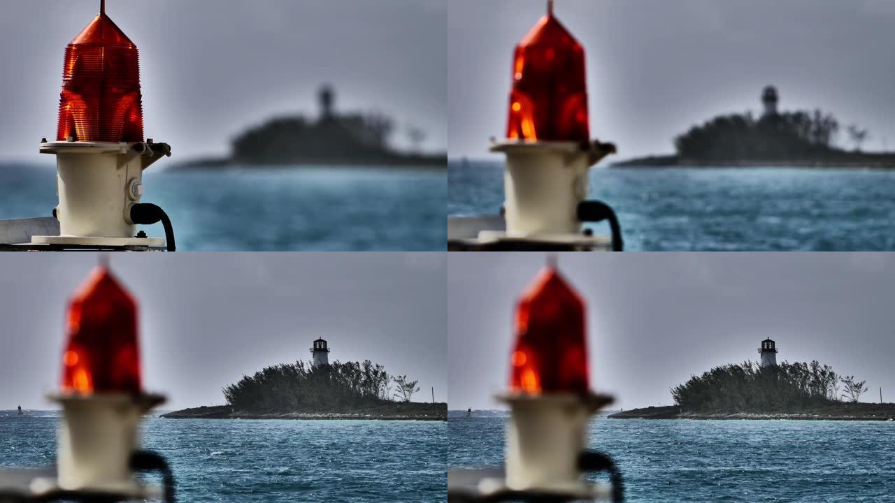 码头上的橙色信号灯灯泡和灯塔穿越水域巴哈马