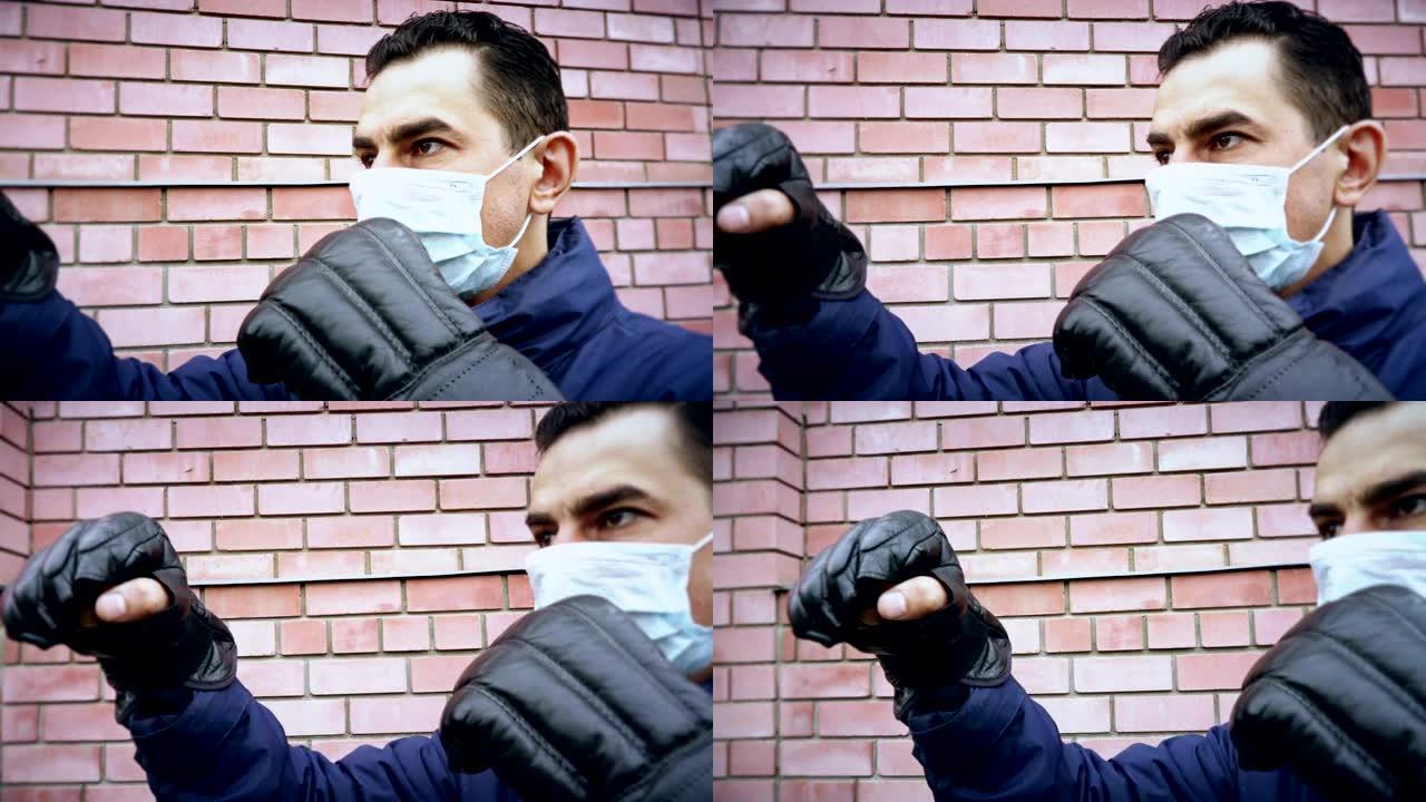 戴着拳击手套的蒙面男子，发疯了，试图保护自己免受看不见的威胁，与病毒，忧郁症，偏执狂作斗争