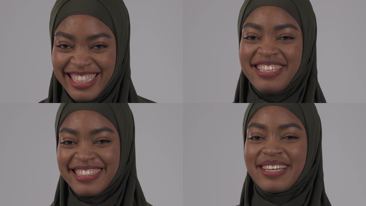 戴着头巾的迷人非洲女人真诚地笑。真实情感概念。隔离在白色背景上
