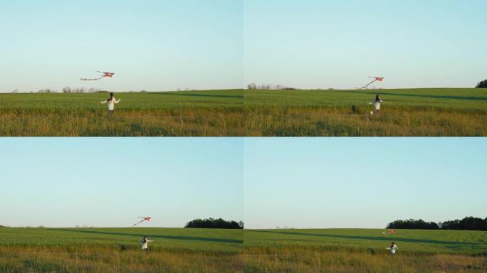 在田野里用风筝奔跑的女孩
