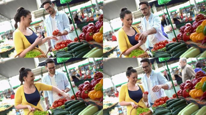 年轻夫妇在农贸市场买蔬菜。