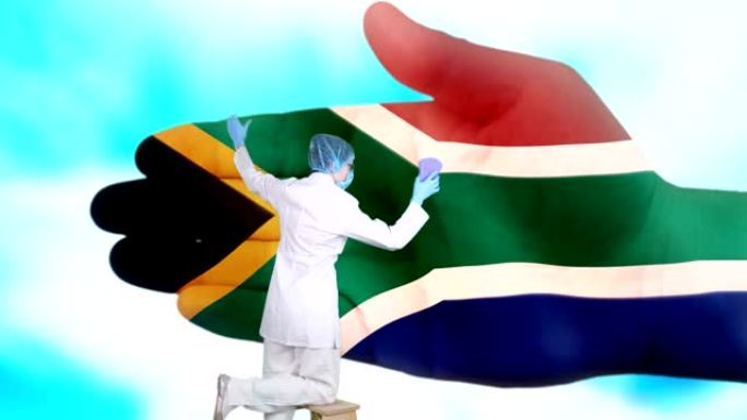 戴着医用口罩和手套的护士洗大手，涂上南非共和国国旗的颜色。国家保健。洗手概念。病毒保护。疾病预防