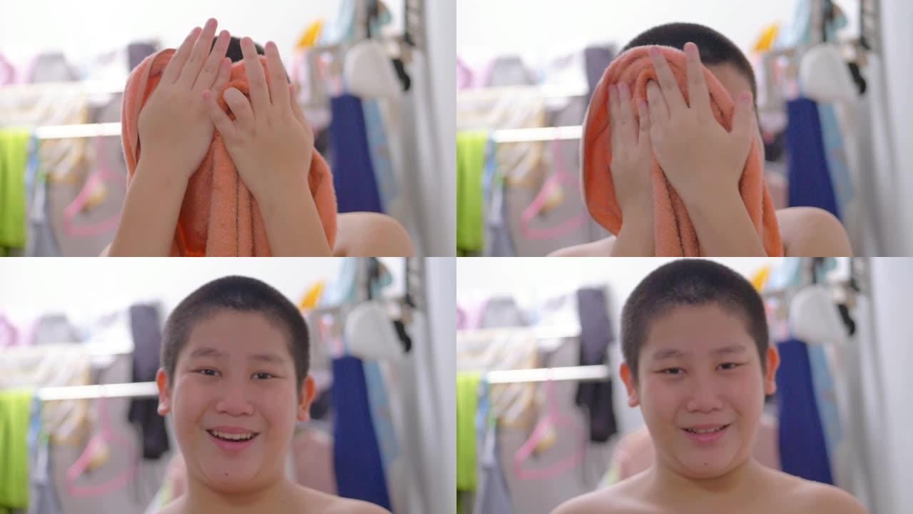 亚洲男孩用毛巾擦身，良好的卫生习惯，每天例行公事