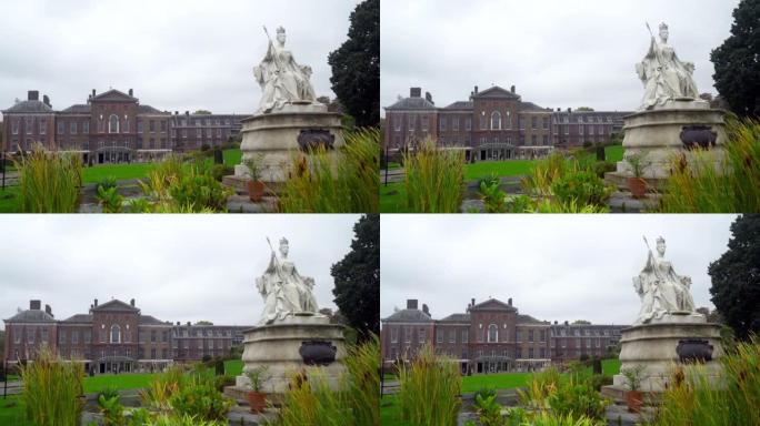 旧建筑背景下的花园女王雕塑。行动。美丽的女王雕塑位于旧庄园附近的公园