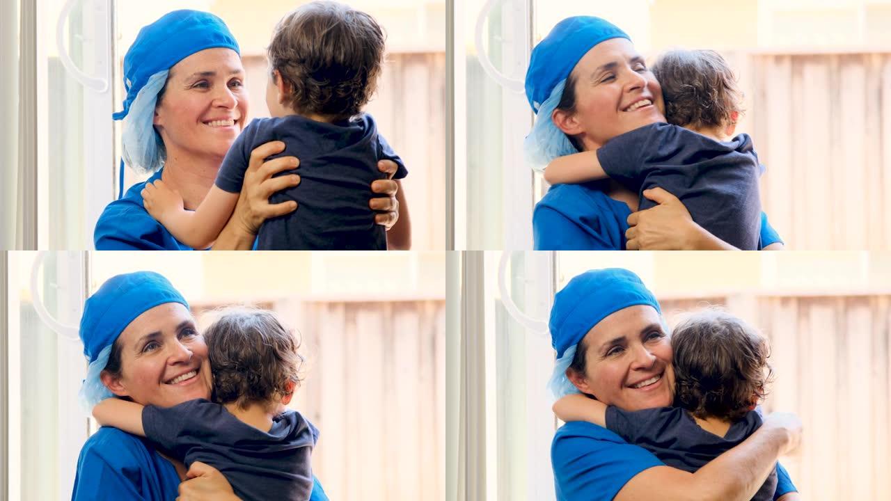 小男孩拥抱他的母亲，他是一名医护人员，他已经好几个星期没见了，因为她正忙着治病，因为新型冠状病毒肺炎