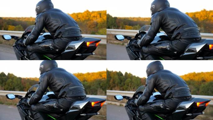 摩托车手在秋天的乡间小路上骑摩托车的特写镜头。戴着头盔的年轻人在高速公路上骑着现代运动摩托车。旅途中