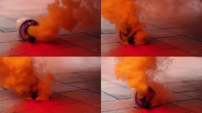 在抗议活动中，街上冒烟的烟雾弹。彩色烟雾特写。城市街道上的骚乱和流氓行为。骚乱期间与警察发生冲突