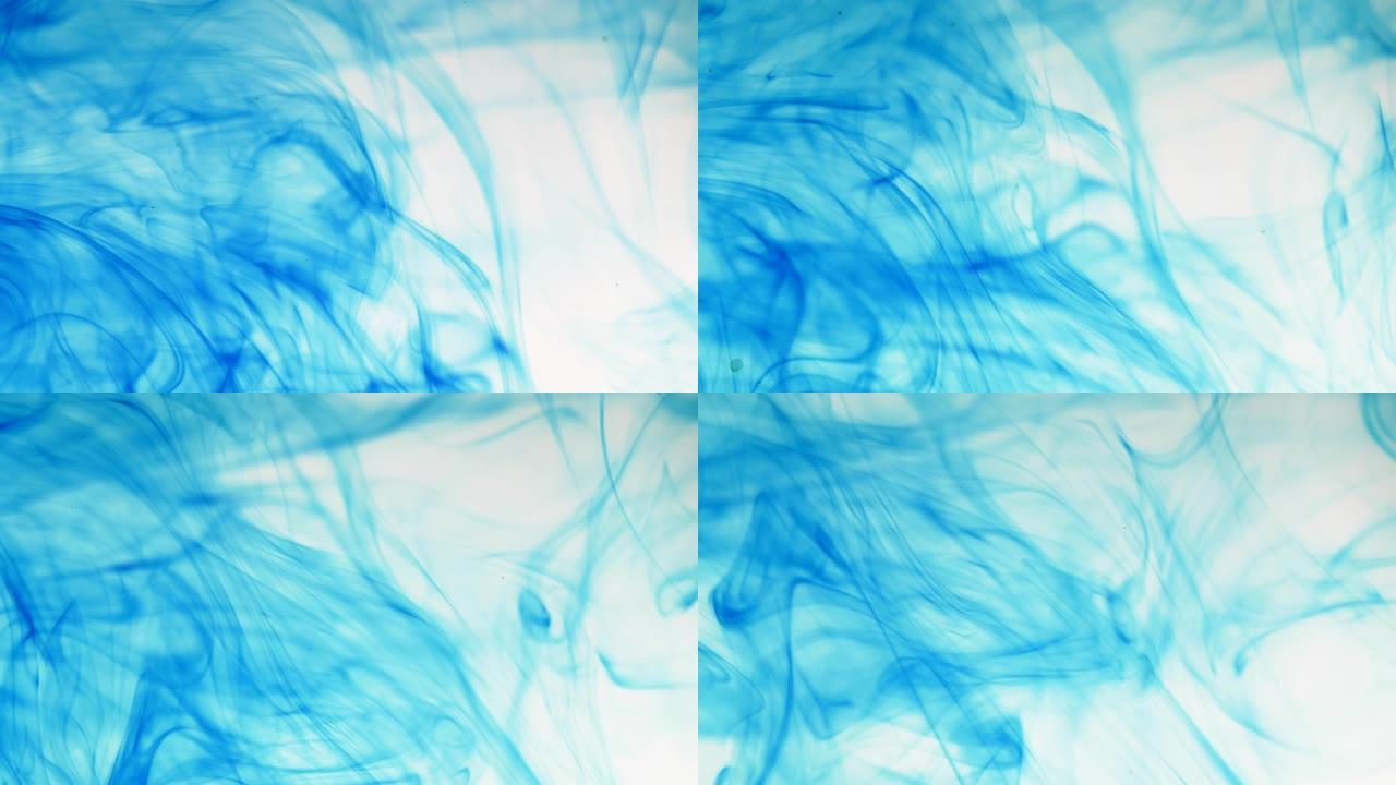 蓝色墨水的运动在水中落下，形成抽象的背景。