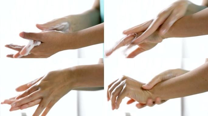 特写女性手部使用护手霜泡沫护理在她的手上，女性皮肤护理。