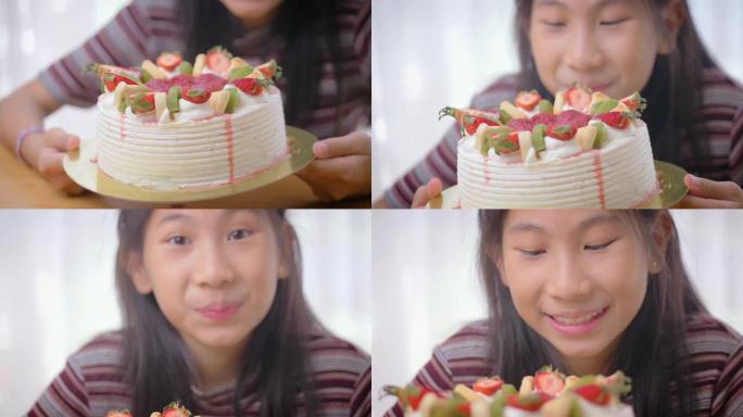 女孩在桌子上闻到自制的水果蛋糕，生活方式的概念。