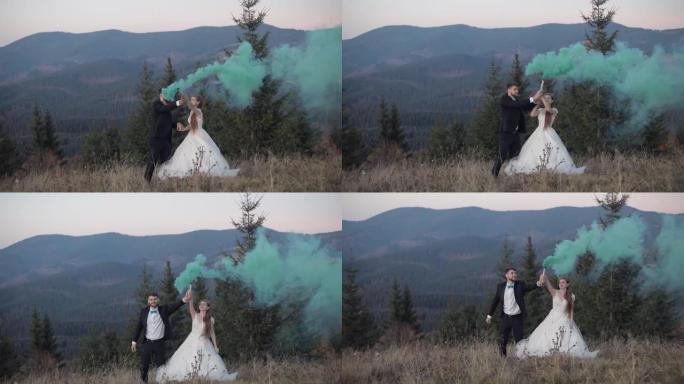 新婚夫妇。高加索新郎和新娘在山坡上带着烟雾弹