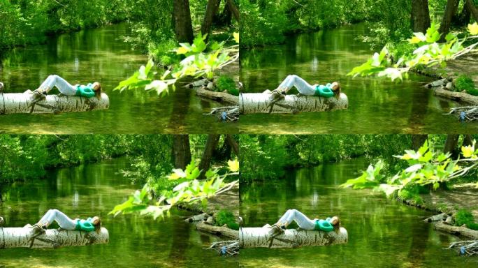 年轻女子在森林灌木丛中的河上休息