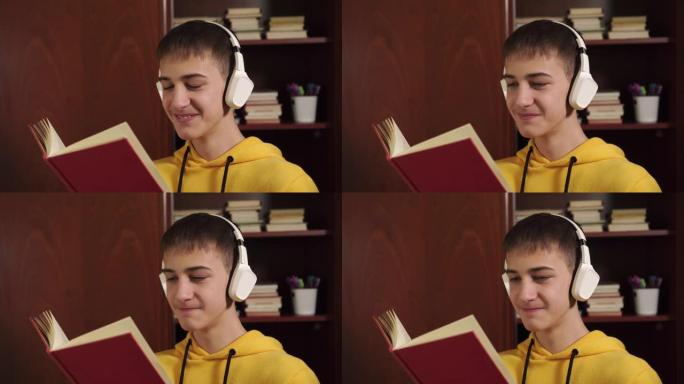 一个年轻的学生在一个木制书柜的背景上读一本耳机在网上学习的书的特写