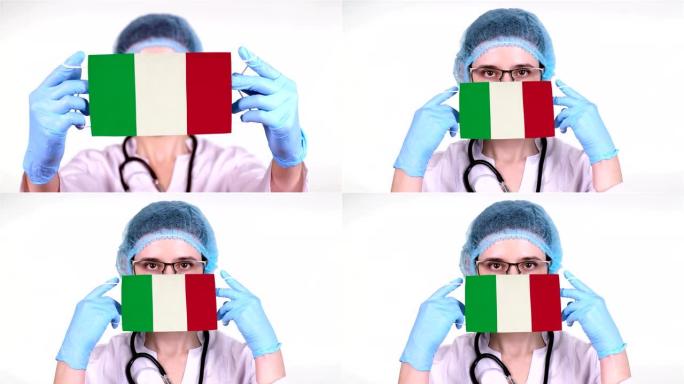 特写。戴眼镜的医生，蓝色医疗帽，手套手持带有意大利国旗的医用口罩。医生护理，冠状病毒期间国家保护，全