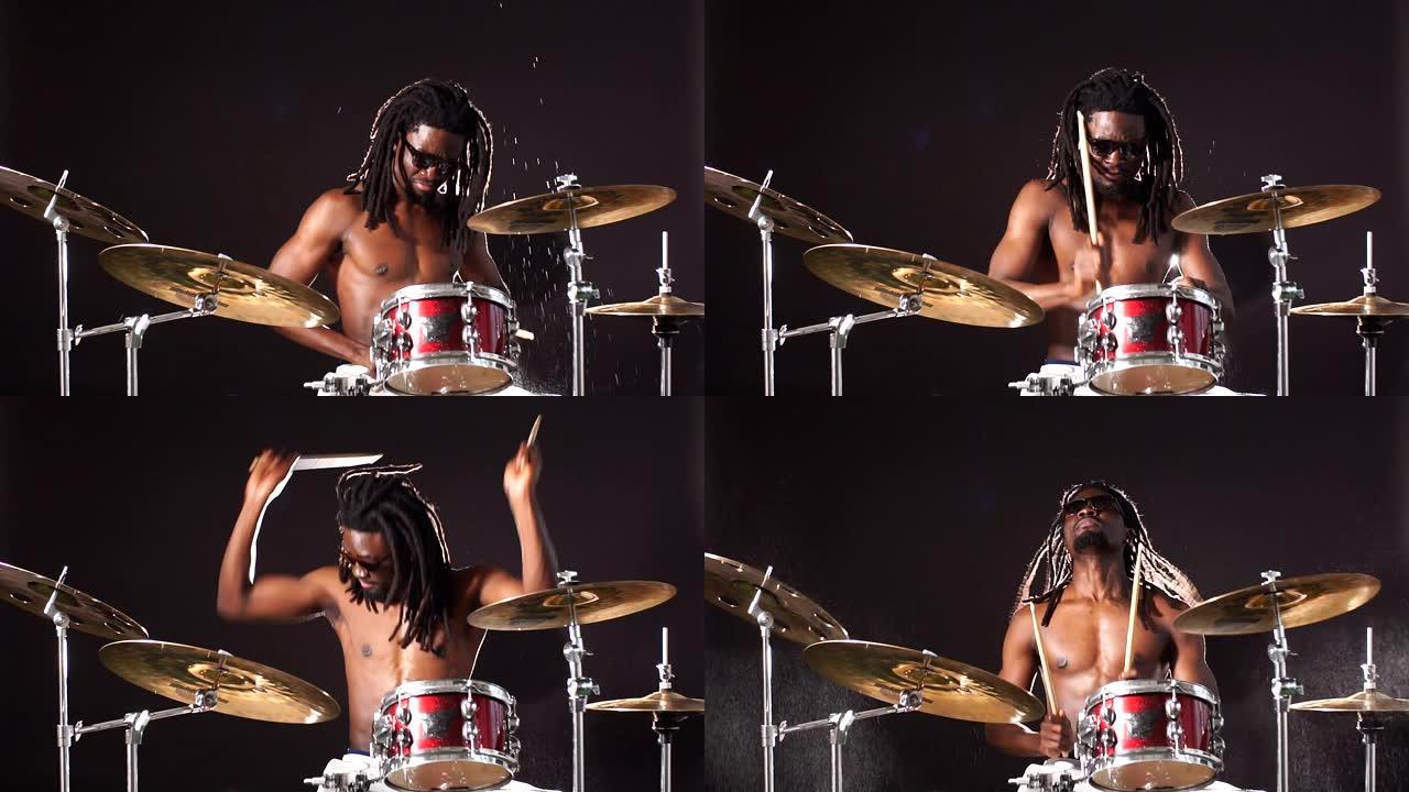 活跃的非洲男子在音乐工作室的鼓上演奏的肖像