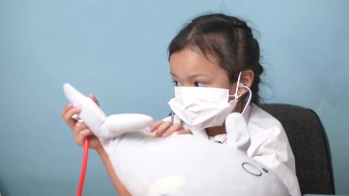 亚洲女孩用动物娃娃扮演医生，儿童生活方式概念。