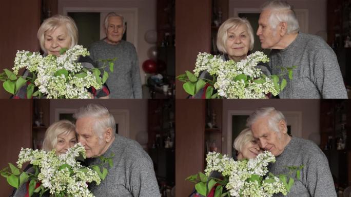 一个快乐的祖父和祖母的肖像。爷爷亲吻认真