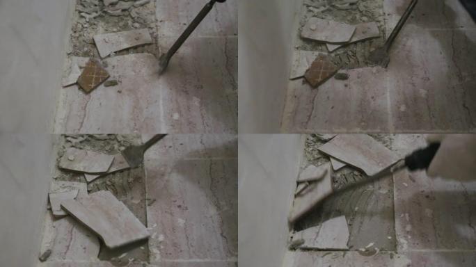 工人从浴室的地板上取下旧瓷砖