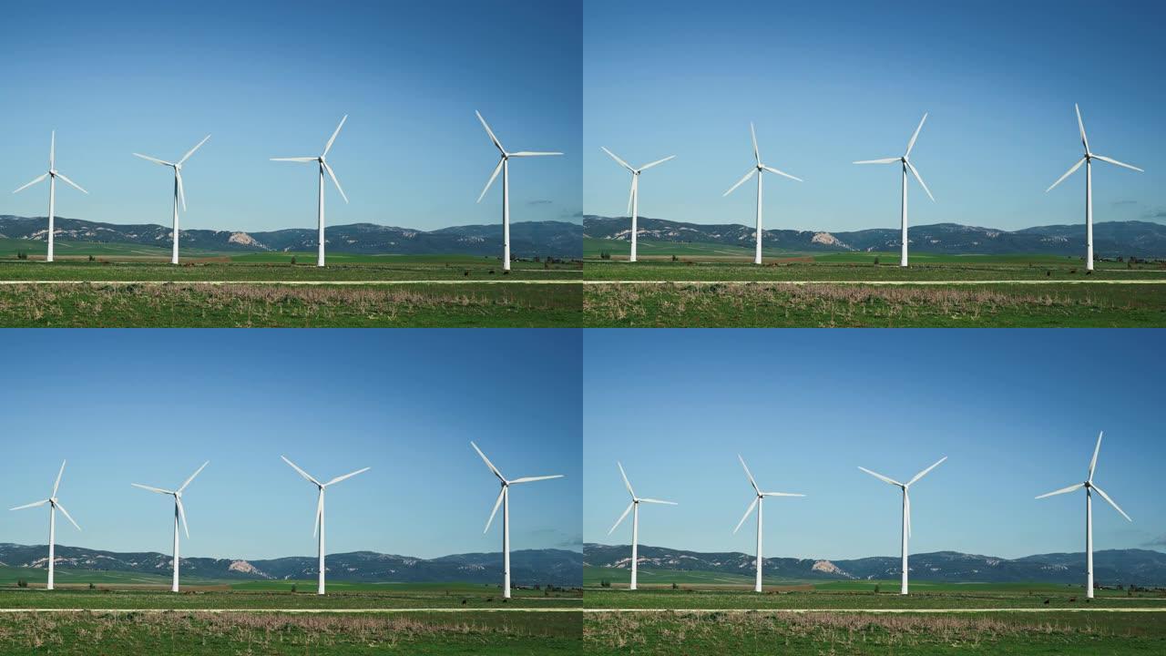 在西班牙的山脉背景上拍摄了四个风车的万向节镜头