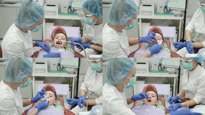 年轻女孩牙医，医生做牙齿检查的孩子。高质量的儿童药品是健康的保证。医生刷他们露齿的病人。现代医疗工具