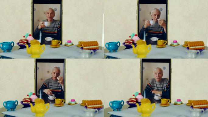 老人使用视频通话在娃娃桌上喝茶