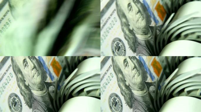 计数机计数许多新样品的100美元的钞票。钱的计数