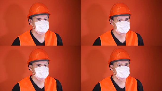 橙色背景上戴着医用面具的年轻人的肖像。成年男性用口罩遮住脸，保护自己免受疾病侵害。冠状病毒流行病或疾