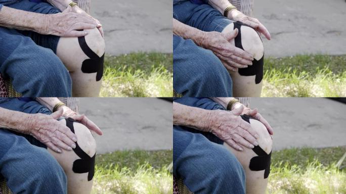 夏季户外中午，老年高加索妇女的膝关节关节炎疼痛的特写镜头